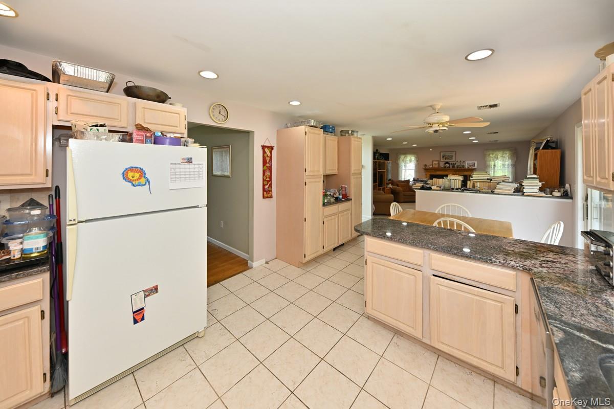 14 Roble Road Suffern, NY 10901 - Photo 30 of 30 Kitchen featuring freestanding refrigerator, recessed lighting, light brown cabinets, open floor plan, and light tile patterned floors