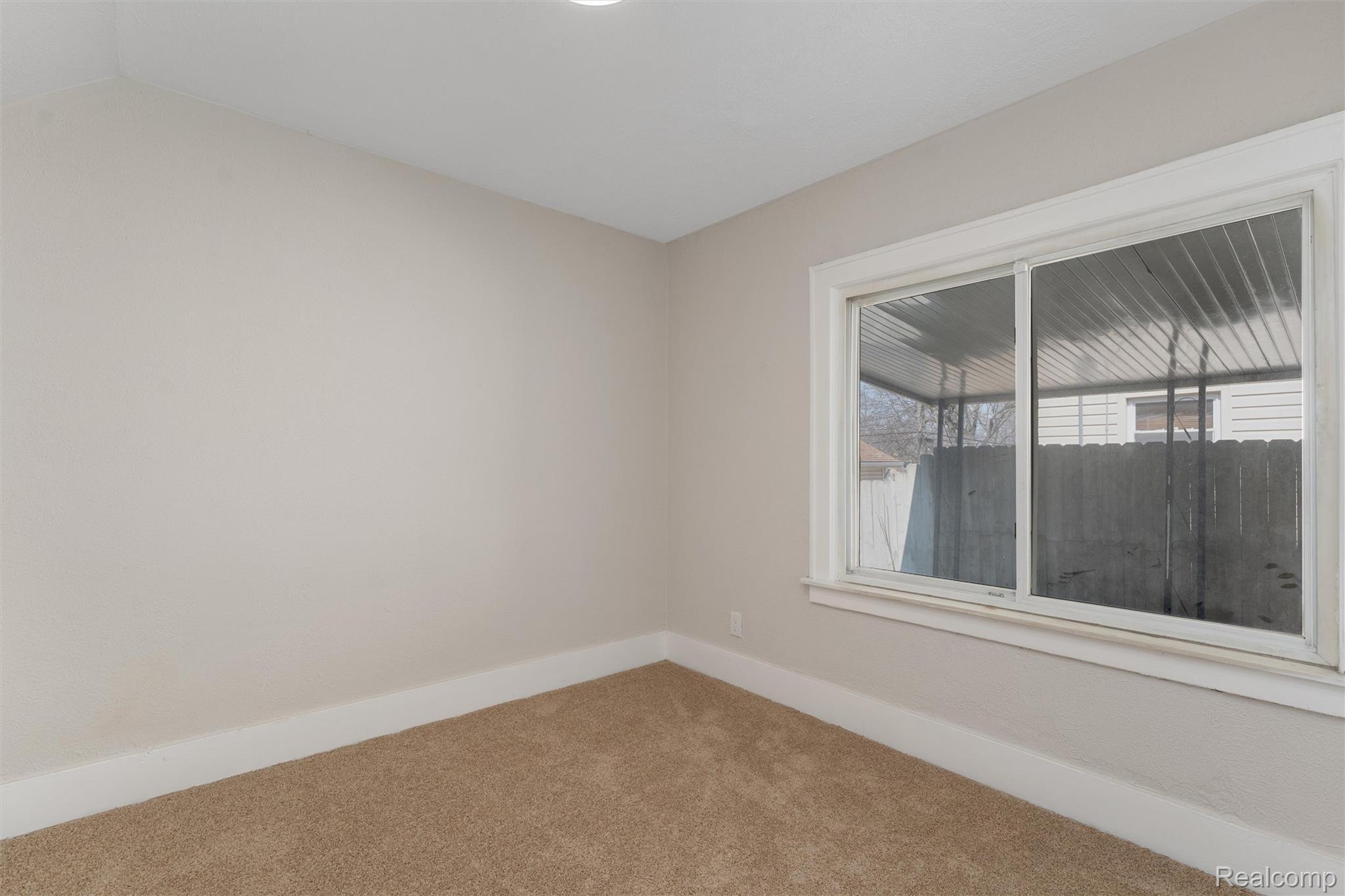 917 Perry Street Pontiac, MI 48340 - Photo 19 of 37 Carpeted spare room featuring baseboards