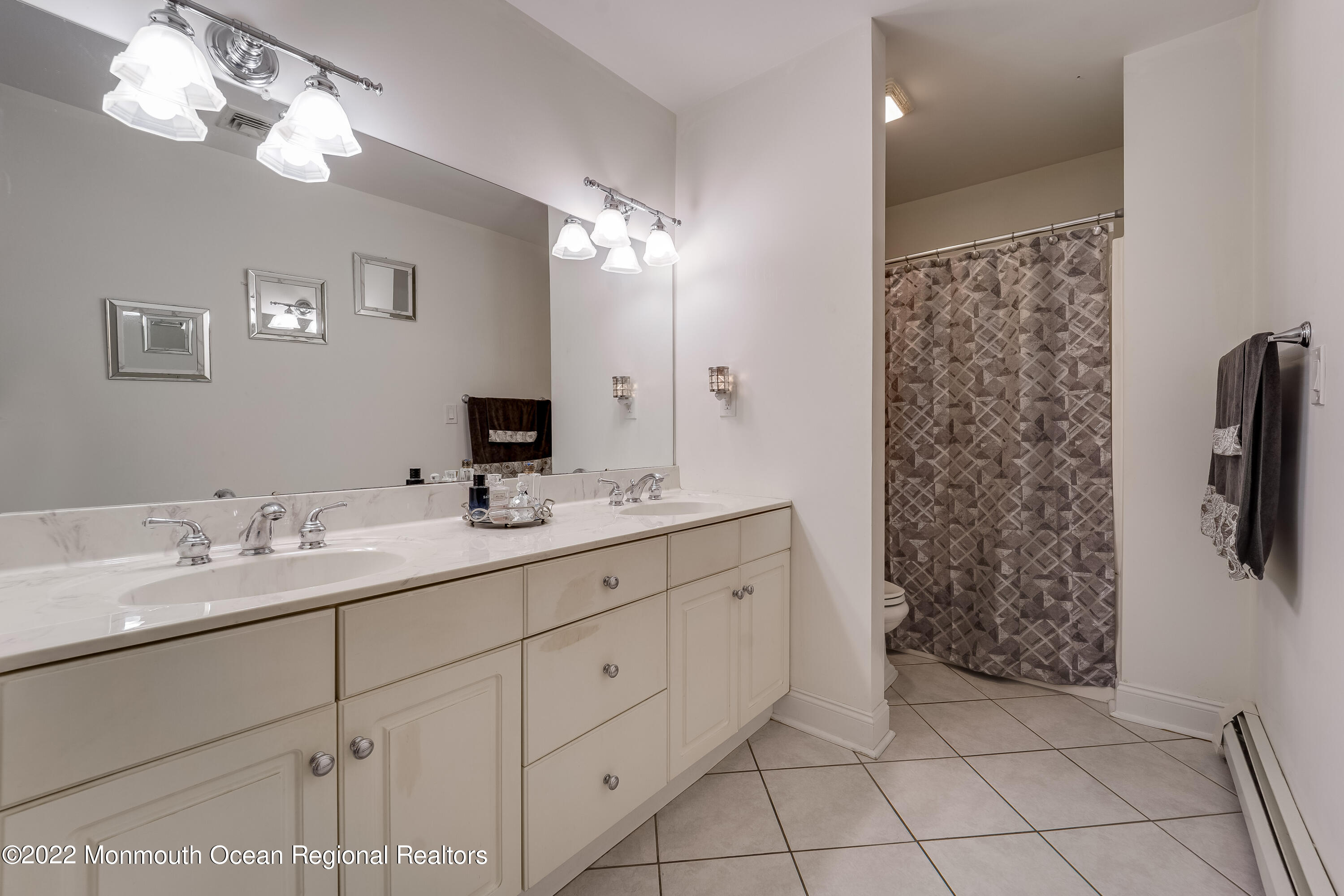 77 Pleasant Hill Road Randolph, NJ 07869 - Photo 44 of 85 a bathroom with a double vanity sink and a mirror