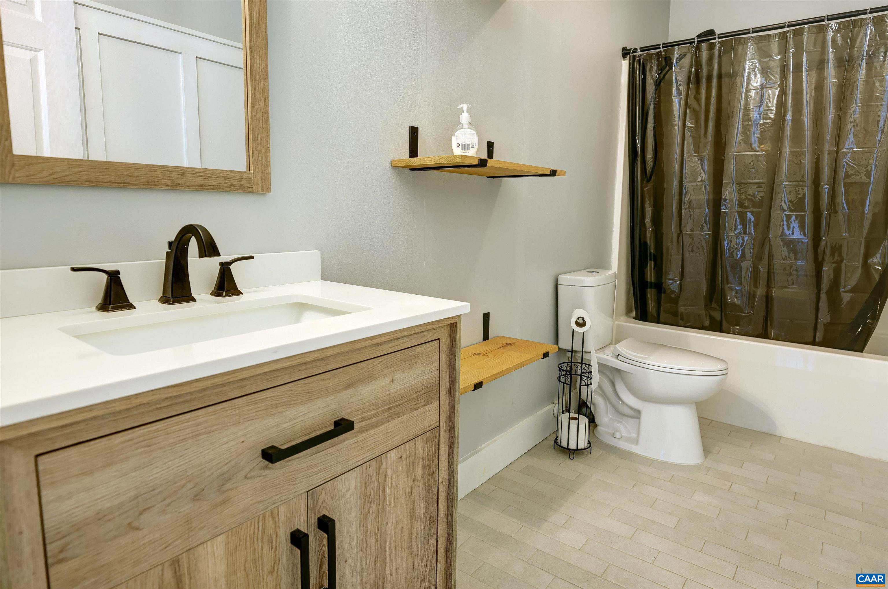 14 High View Road Stanardsville, VA 22973 - Photo 18 of 41 a bathroom with a sink a toilet and mirror