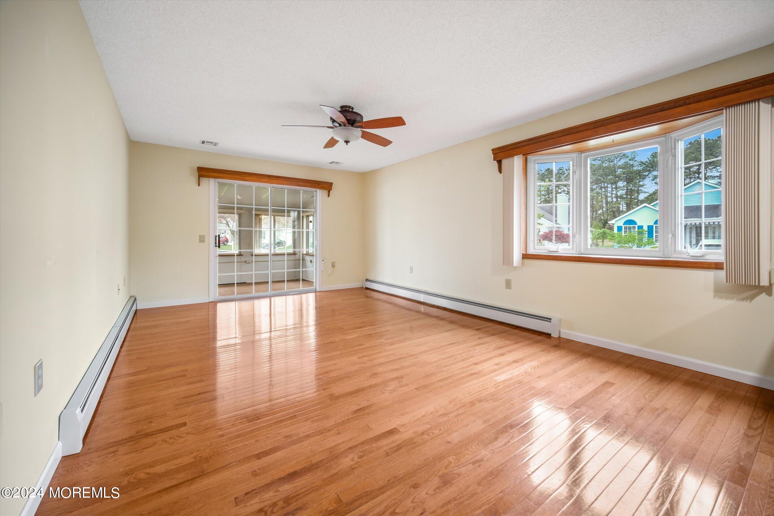1 Lambert Way Toms River, NJ 08757 - Photo 11 of 26 a view of an empty room with wooden floor and a window