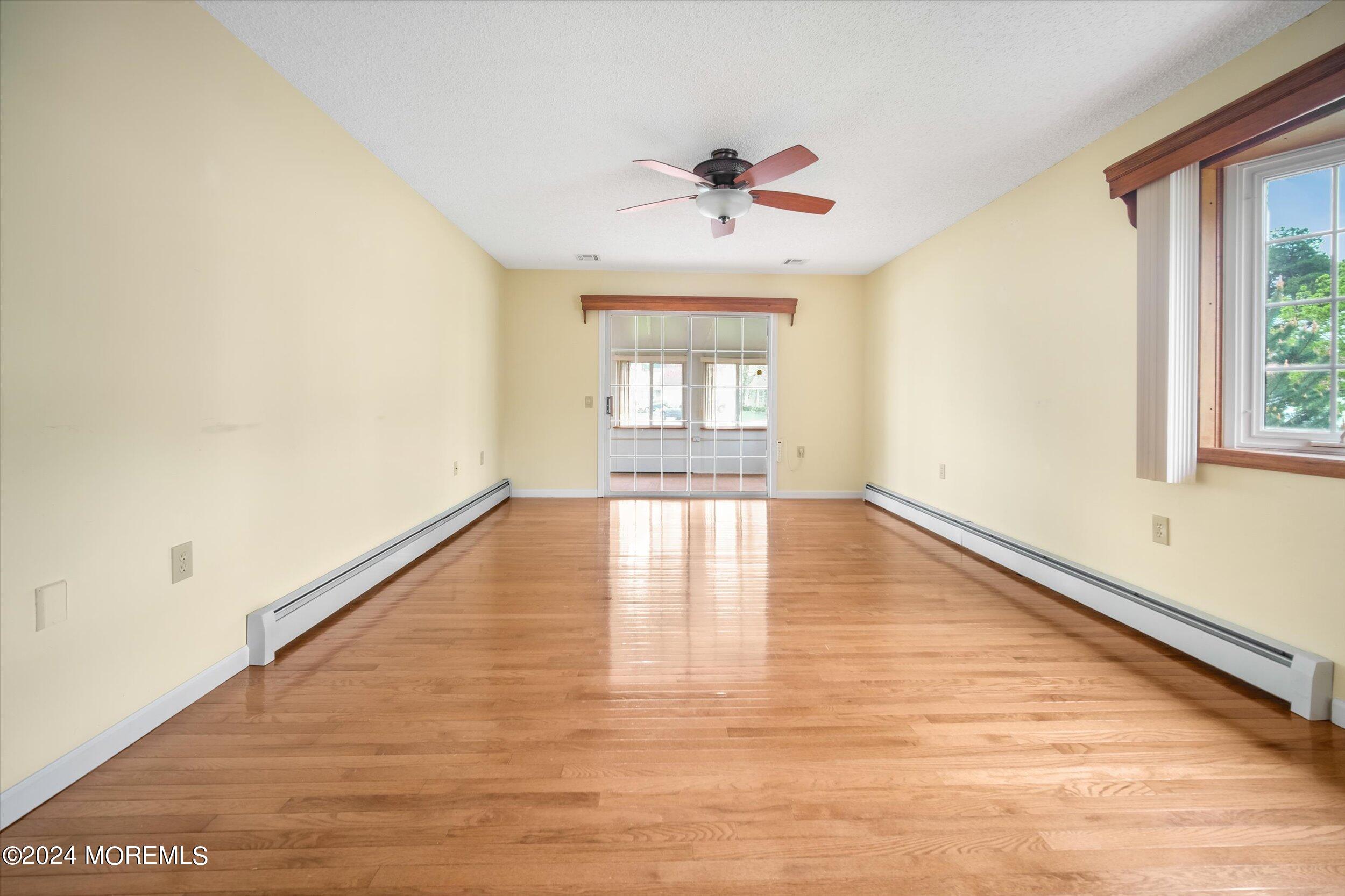 1 Lambert Way Toms River, NJ 08757 - Photo 12 of 26 a view of an empty room with wooden floor and a window