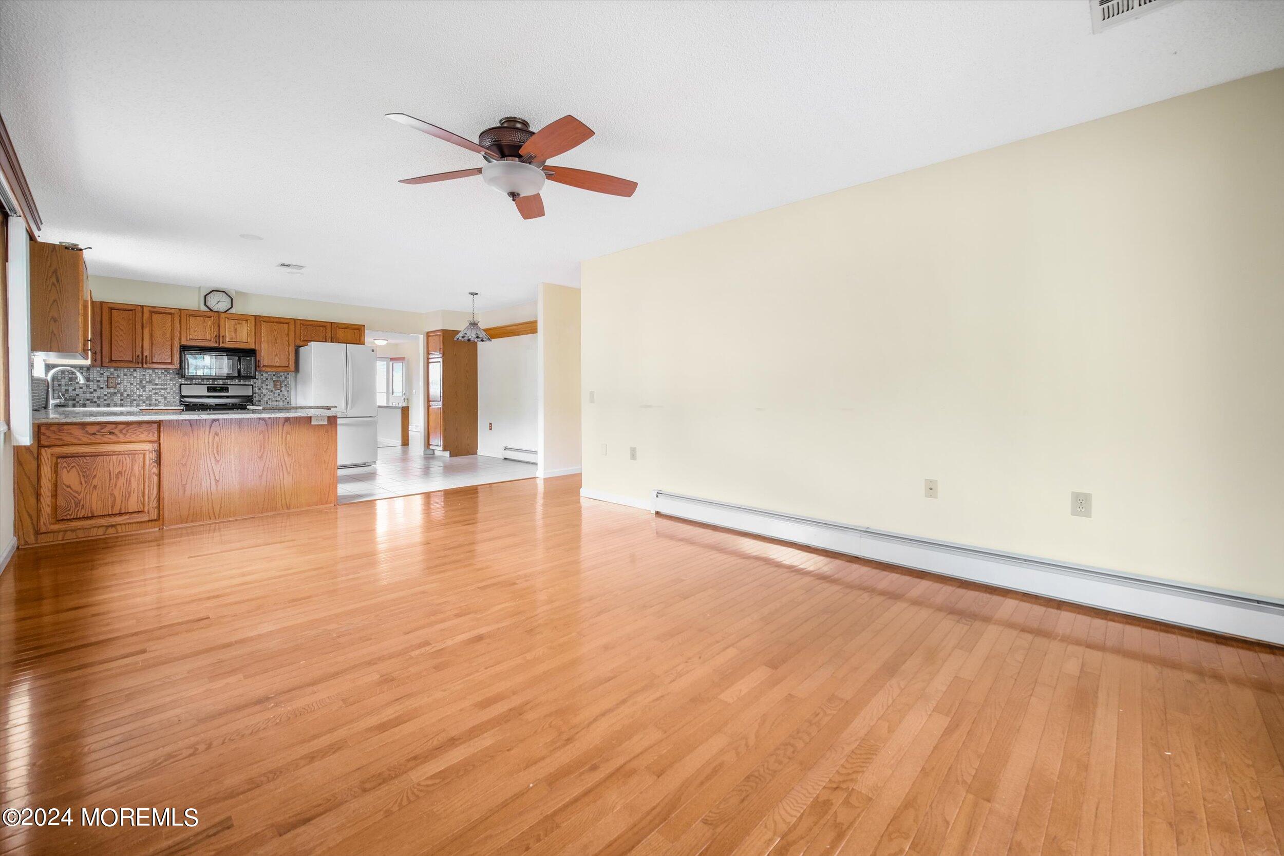 1 Lambert Way Toms River, NJ 08757 - Photo 13 of 26 a view of a room with wooden floor and a ceiling fan