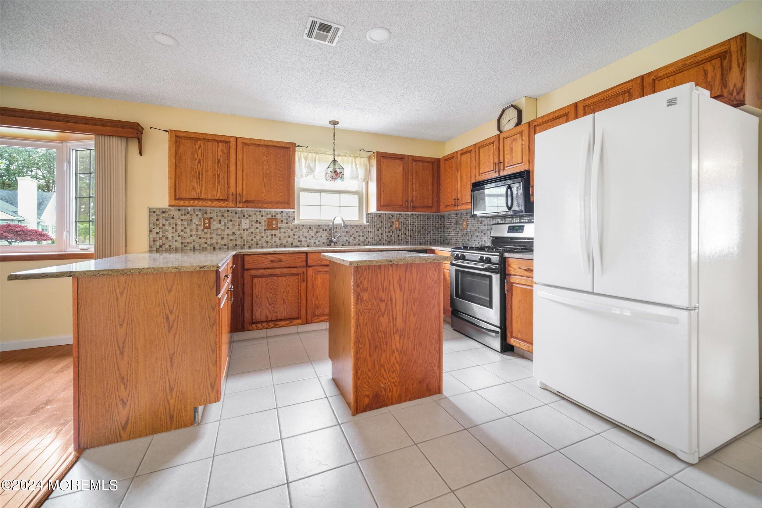 1 Lambert Way Toms River, NJ 08757 - Photo 15 of 26 a kitchen with stainless steel appliances granite countertop a refrigerator sink and cabinets