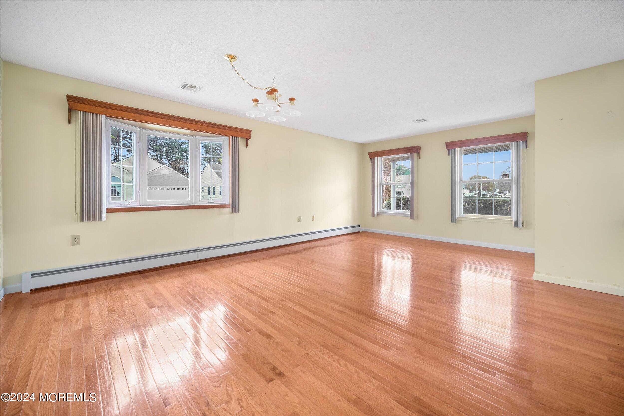 1 Lambert Way Toms River, NJ 08757 - Photo 7 of 26 a view of an empty room with wooden floor and a window