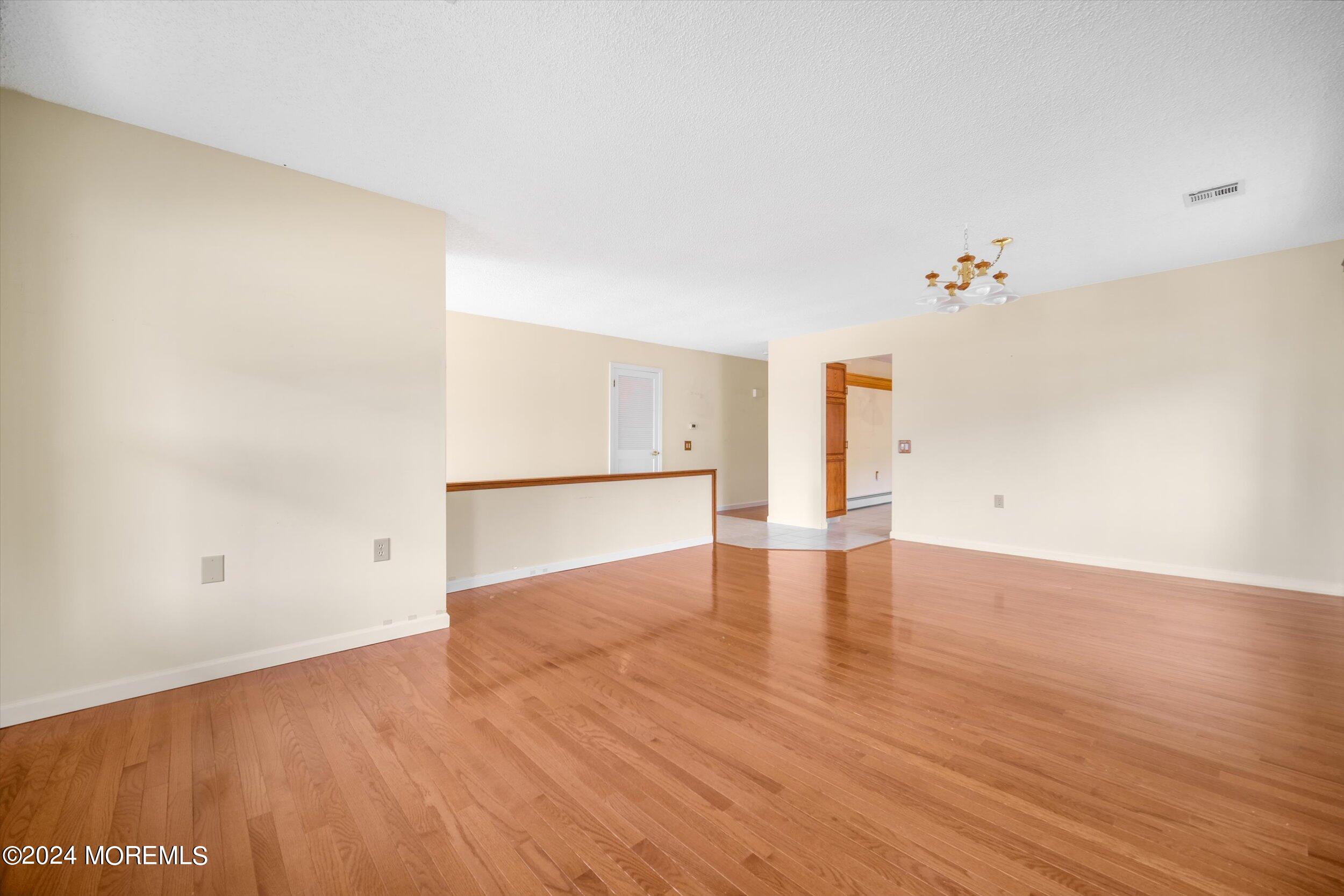 1 Lambert Way Toms River, NJ 08757 - Photo 8 of 26 an empty room with wooden floor and windows