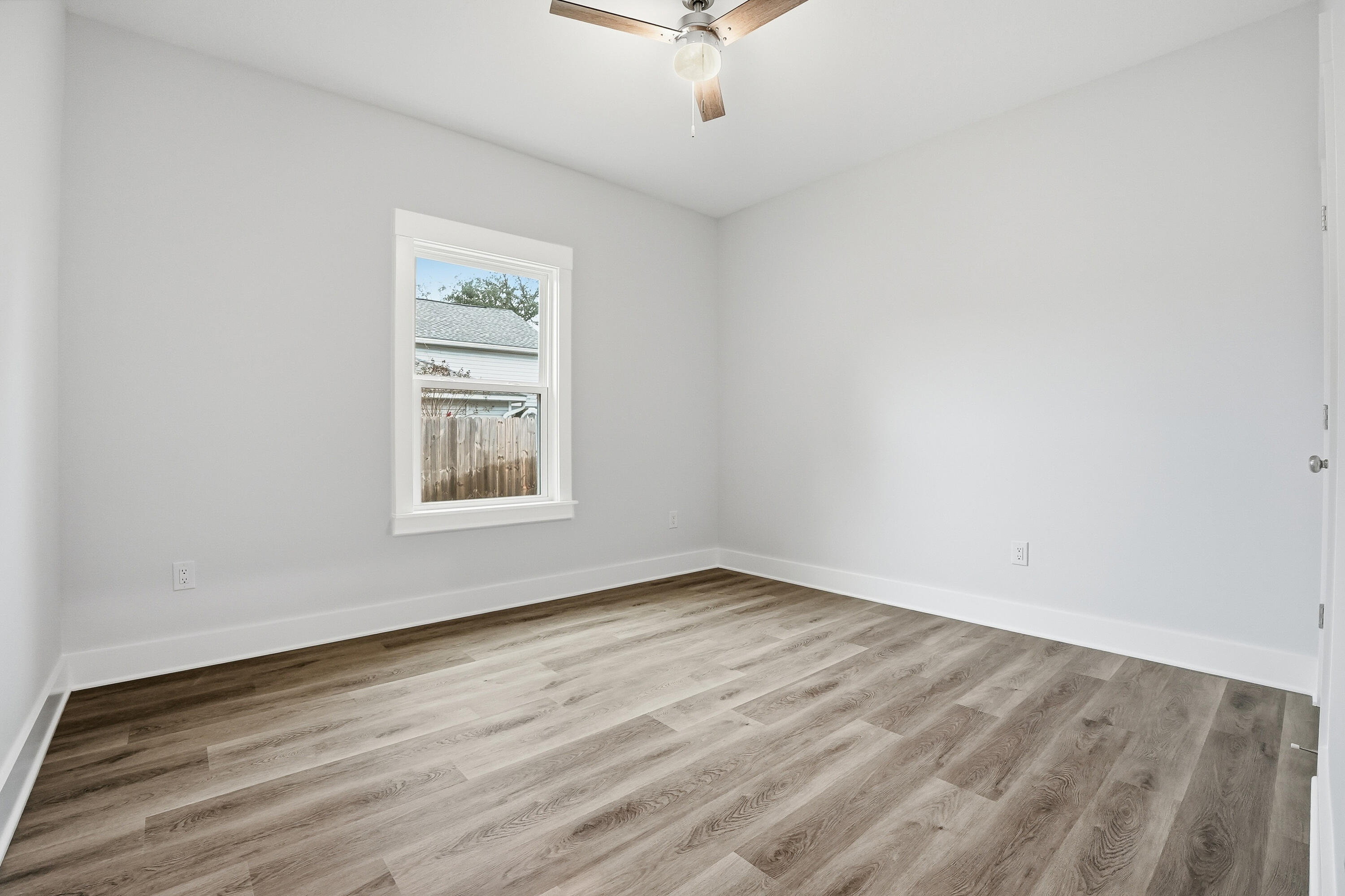15 Plew Avenue Shalimar, FL 32579 - Photo 23 of 67 a view of an empty room with a window and a ceiling fan