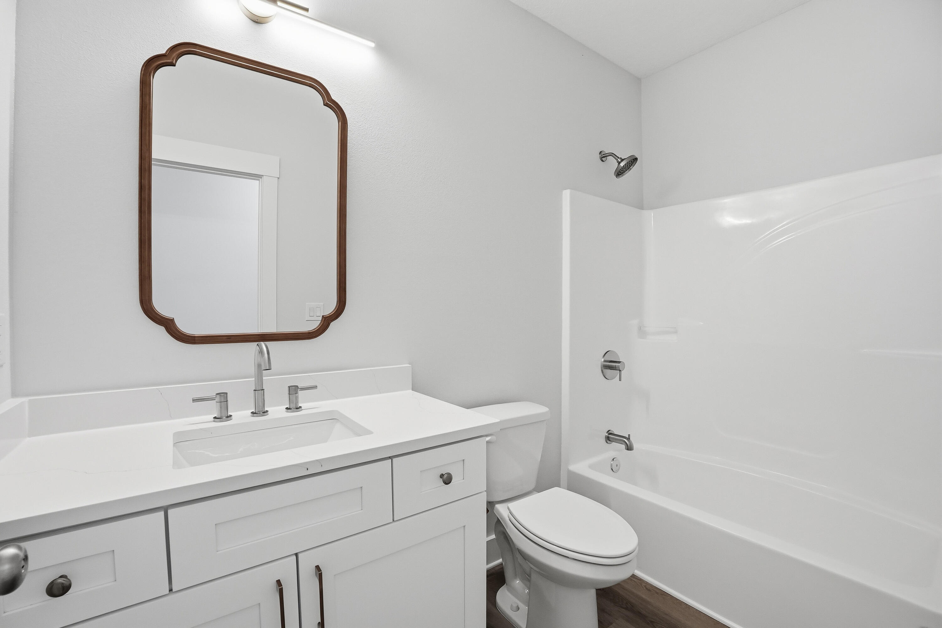 15 Plew Avenue Shalimar, FL 32579 - Photo 25 of 67 a bathroom with a granite countertop toilet a sink and a mirror