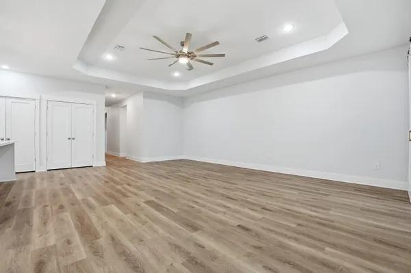 a view of a room with wooden floor