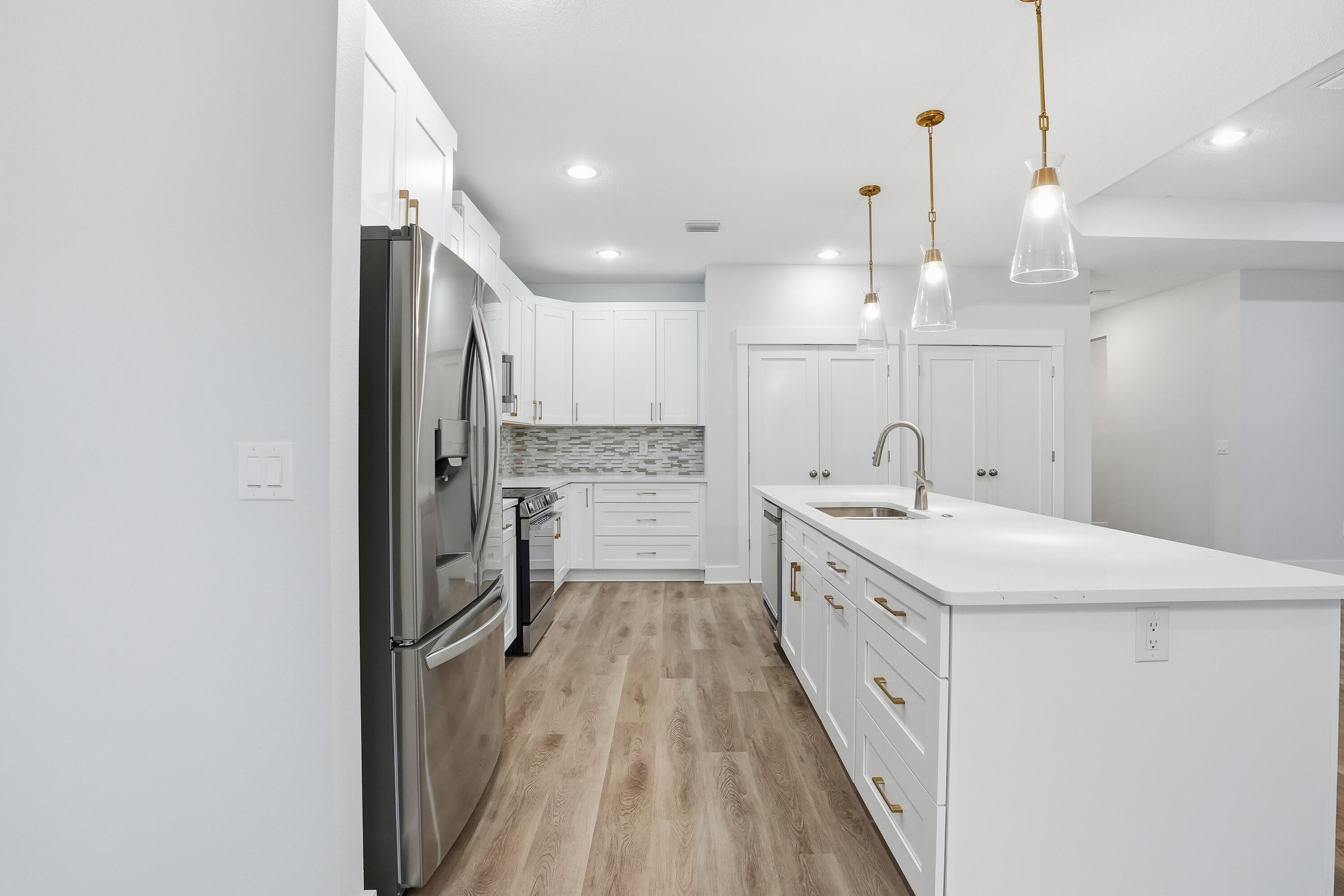 15 Plew Avenue Shalimar, FL 32579 - Photo 33 of 67 a large kitchen with a sink a refrigerator and a stove