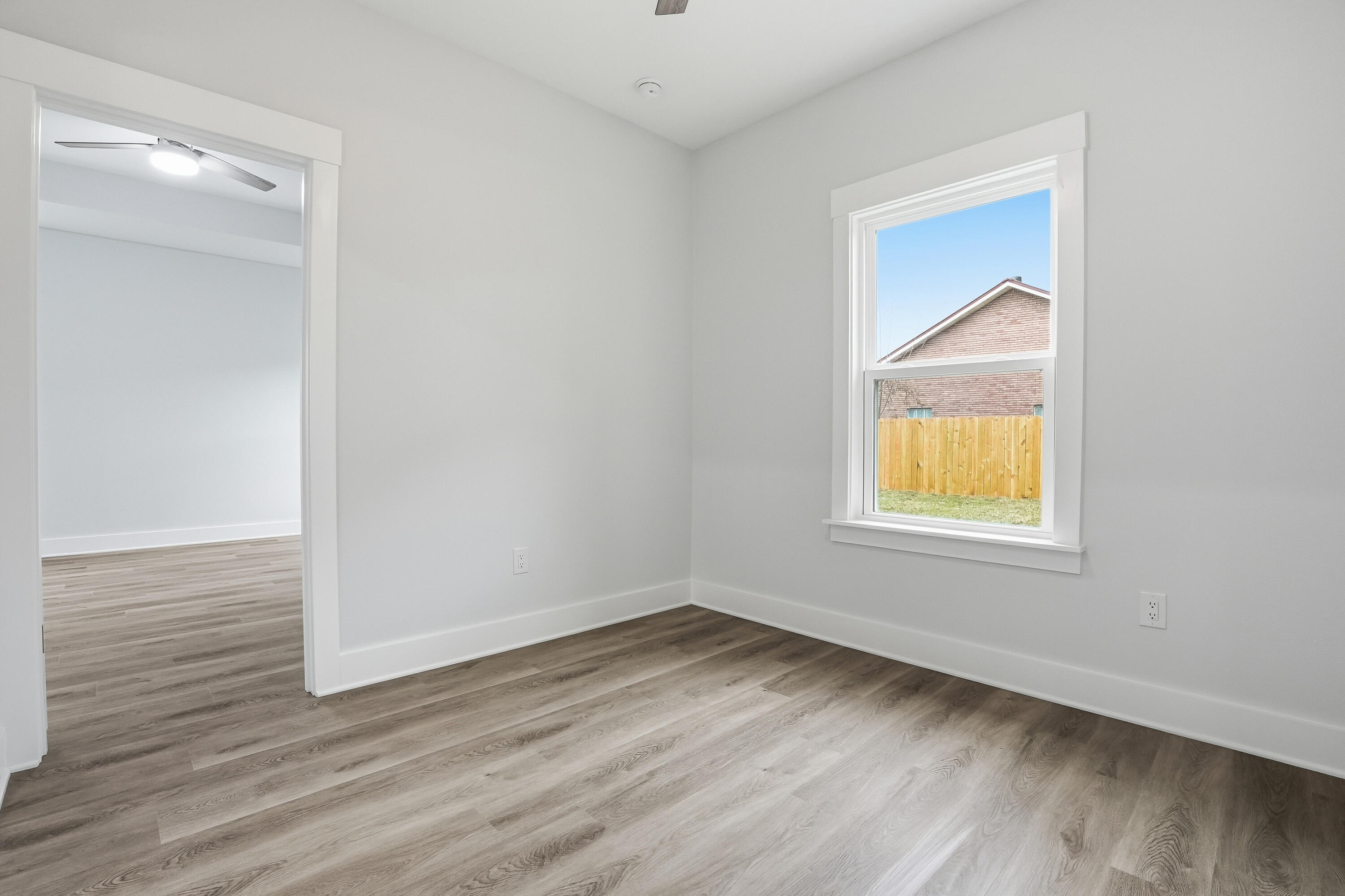 15 Plew Avenue Shalimar, FL 32579 - Photo 43 of 67 an empty room with wooden floor and a window