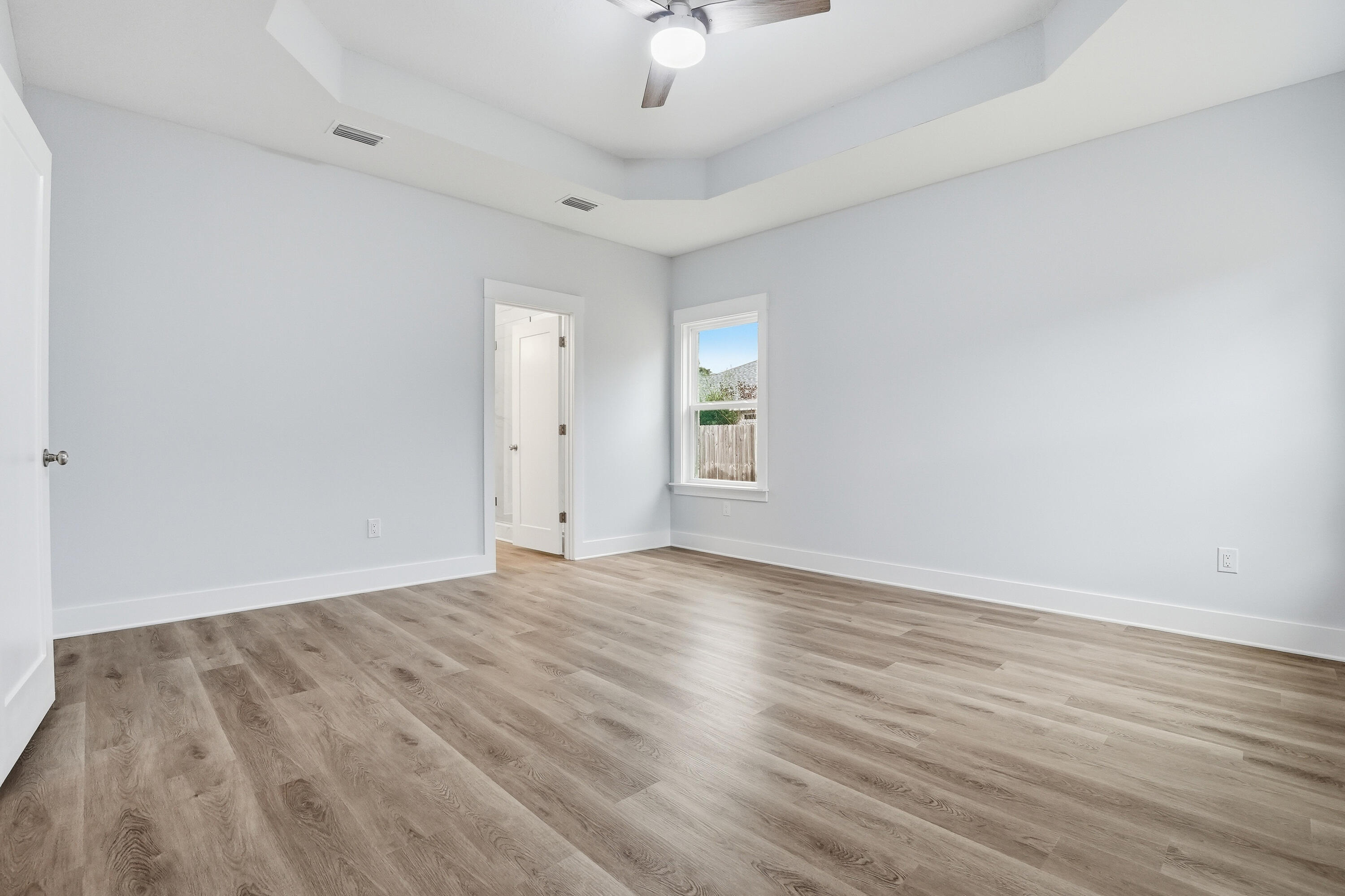 15 Plew Avenue Shalimar, FL 32579 - Photo 46 of 67 an empty room with wooden floor and windows