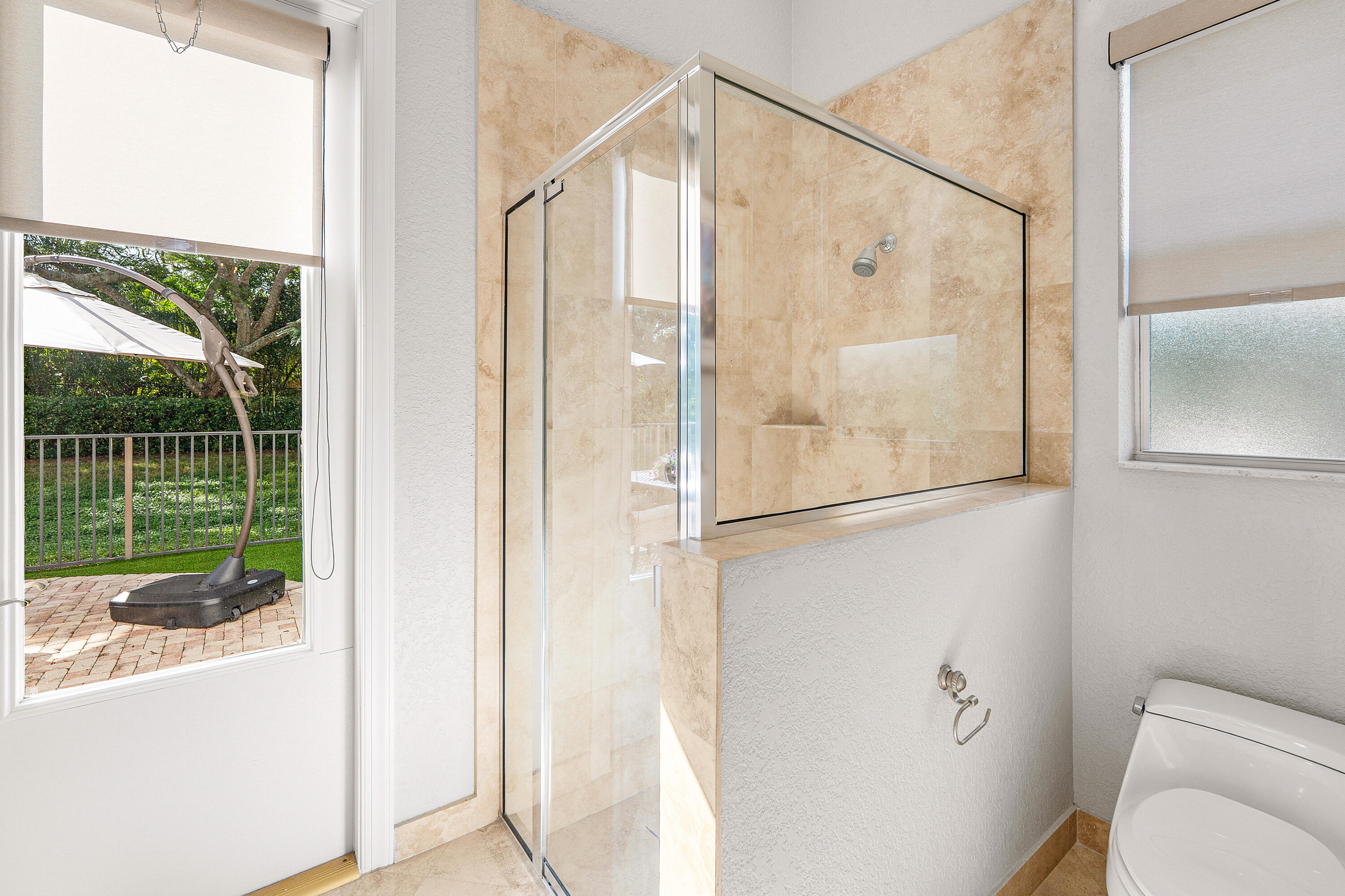 8850 Valhalla Drive Delray Beach, FL 33446 - Photo 26 of 71 a bathroom with a glass shower door