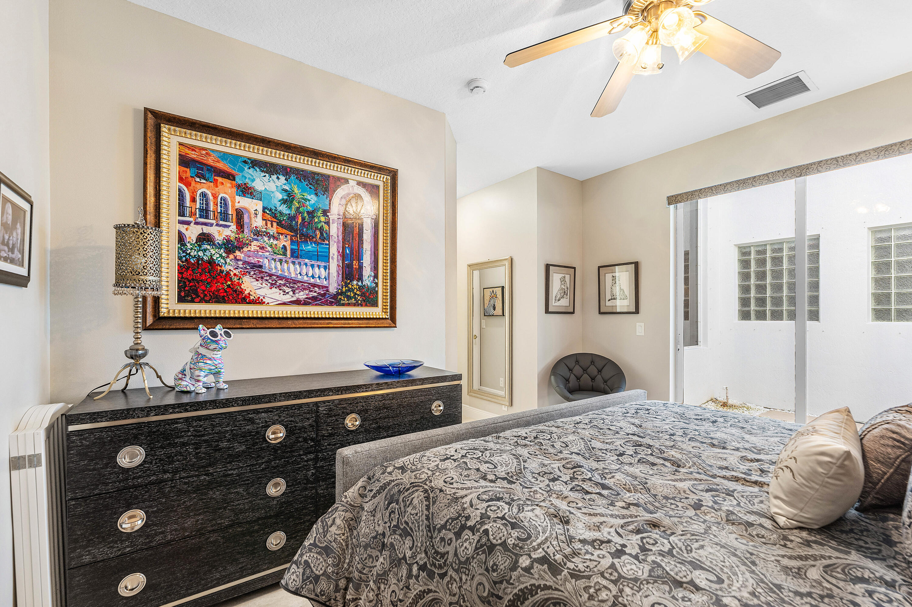 8850 Valhalla Drive Delray Beach, FL 33446 - Photo 41 of 71 a bedroom with a bed and a chandelier