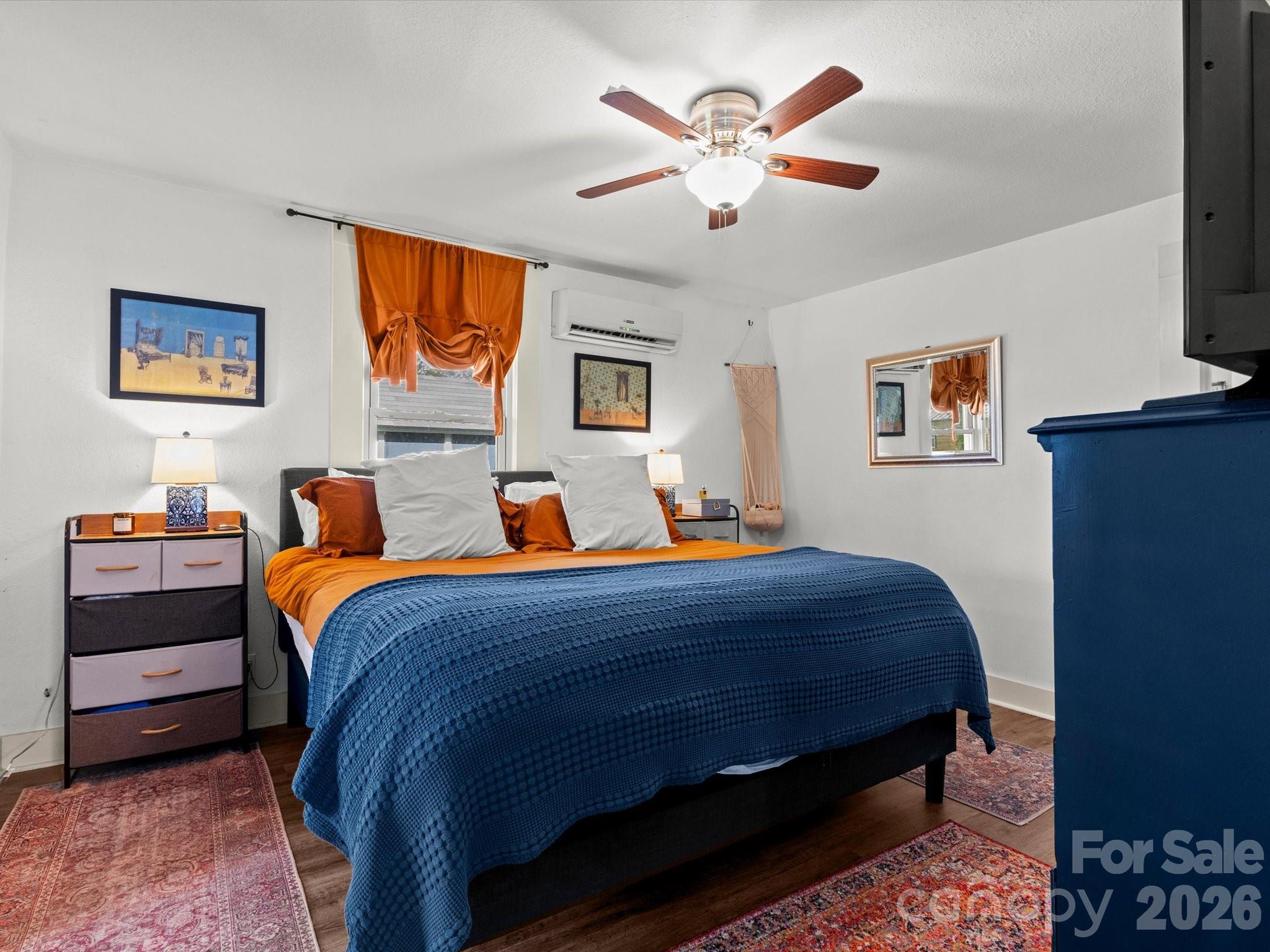 12 Maple Lane Arden, NC 28704 - Photo 16 of 31 a bed room with a bed and a chandelier
