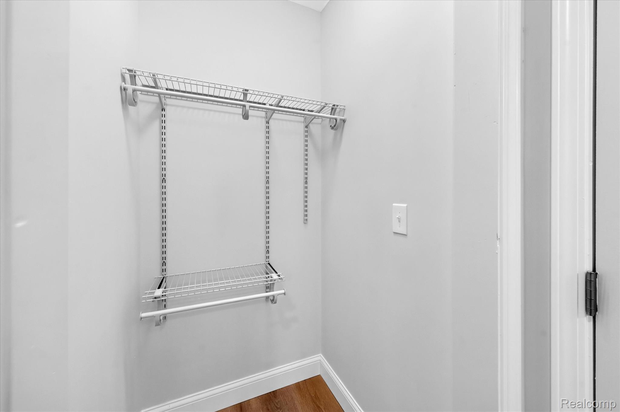 11403 White Lake Road Fenton, MI 48430 - Photo 19 of 36 Configurable wire shelving system with hanging rod and wood-finish flooring