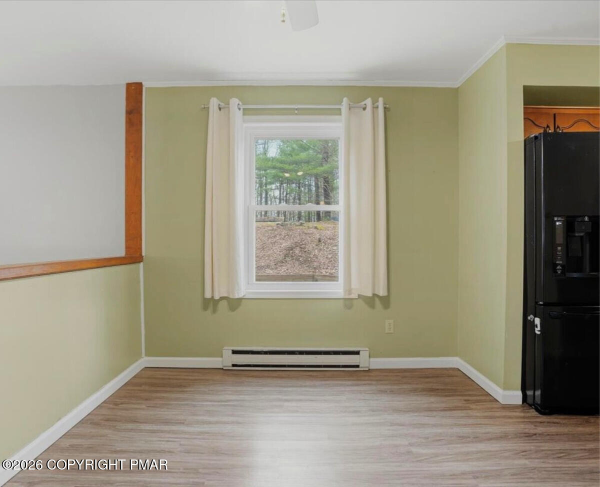 239 Sundance Road Effort, PA 18330 - Photo 17 of 60 an empty room with wooden floor and a window