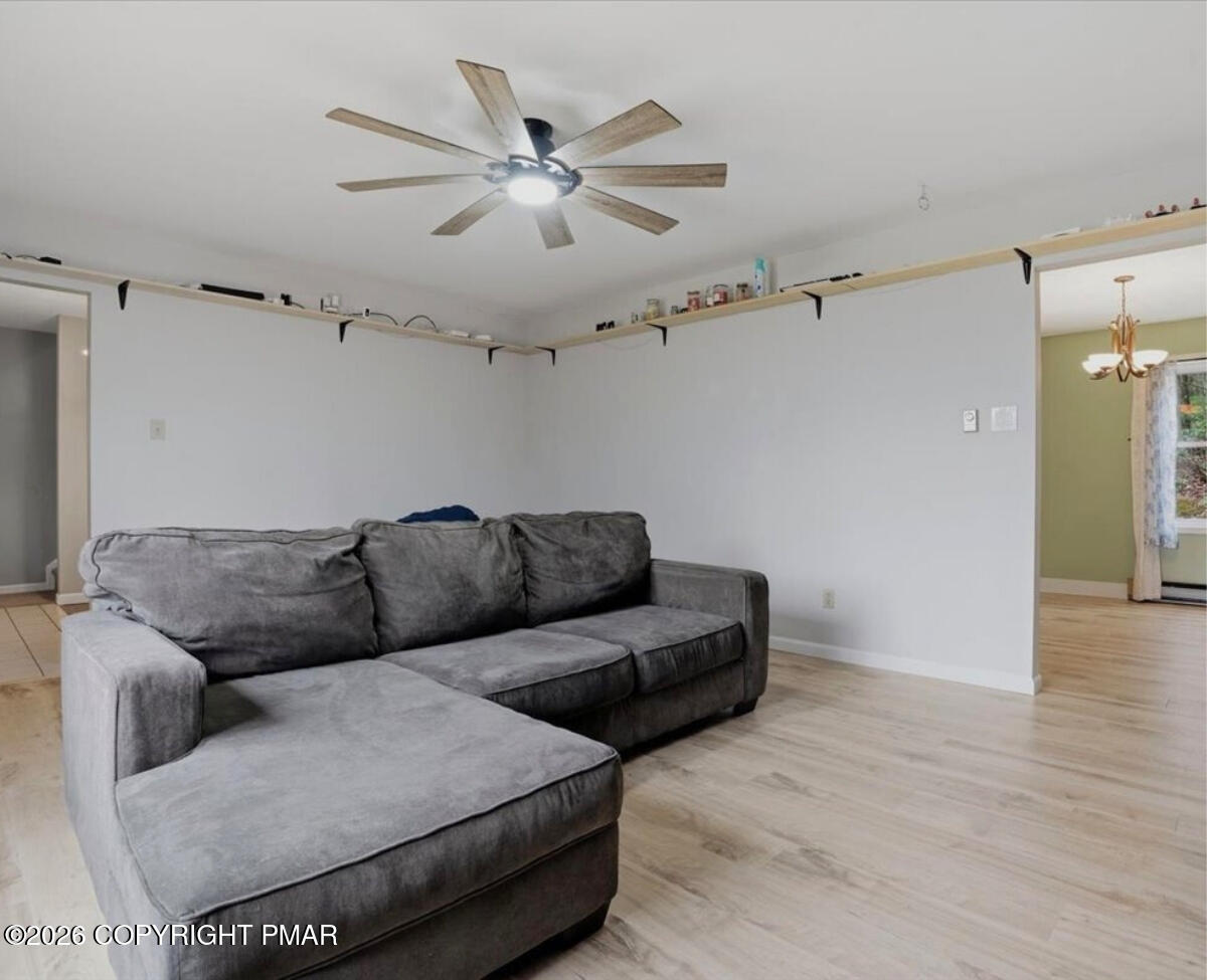 239 Sundance Road Effort, PA 18330 - Photo 7 of 60 a living room with furniture and a ceiling fan