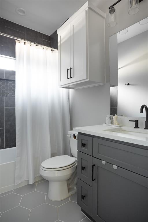 1108 Claude Street Dallas, TX 75203 - Photo 17 of 17 Contemporary bathroom featuring a dark gray vanity with a light countertop, black hardware, and an undermount sink