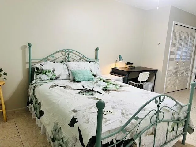 a bed sitting in a bedroom next to a window