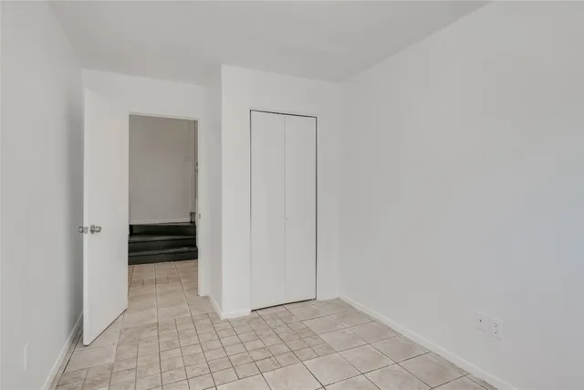 a view of a room with wooden floor and closet