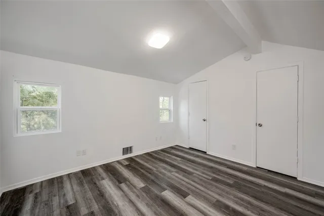 a view of a room with wooden floor