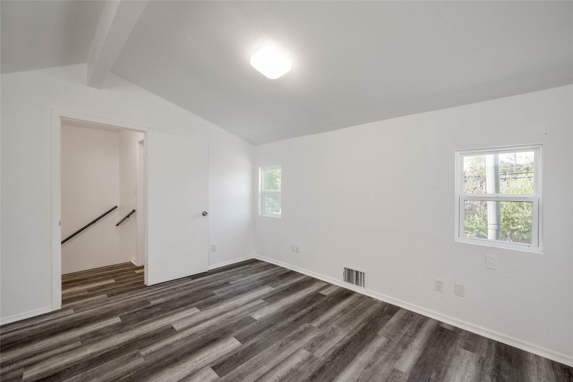 1303 East St Johns Avenue Austin, TX 78752 - Photo 19 of 30 an empty room with wooden floor and windows