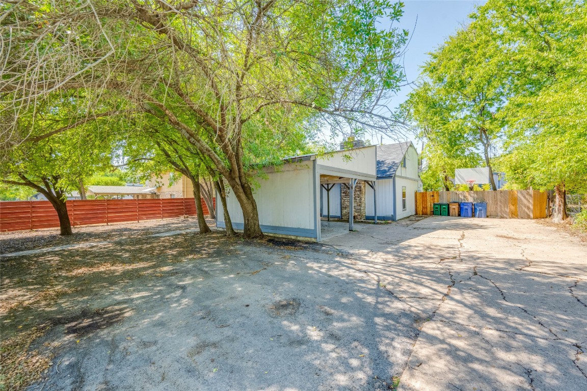 1303 East St Johns Avenue Austin, TX 78752 - Photo 29 of 30 a view of a yard with a tree in the background