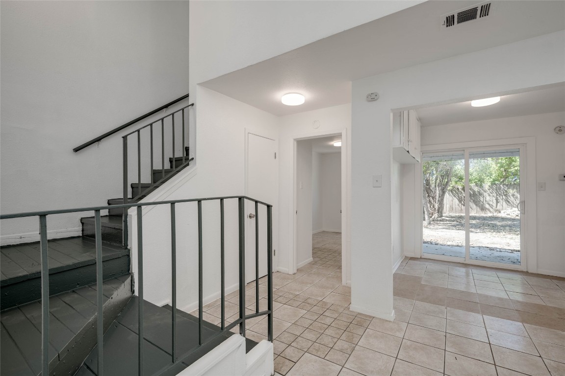 1303 East St Johns Avenue Austin, TX 78752 - Photo 5 of 30 a view of entryway with stairs and wooden floor