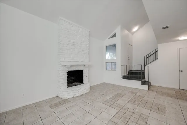 a view of empty room with fireplace