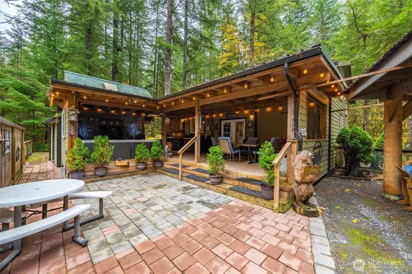 a view of a patio with a table chairs and a backyard