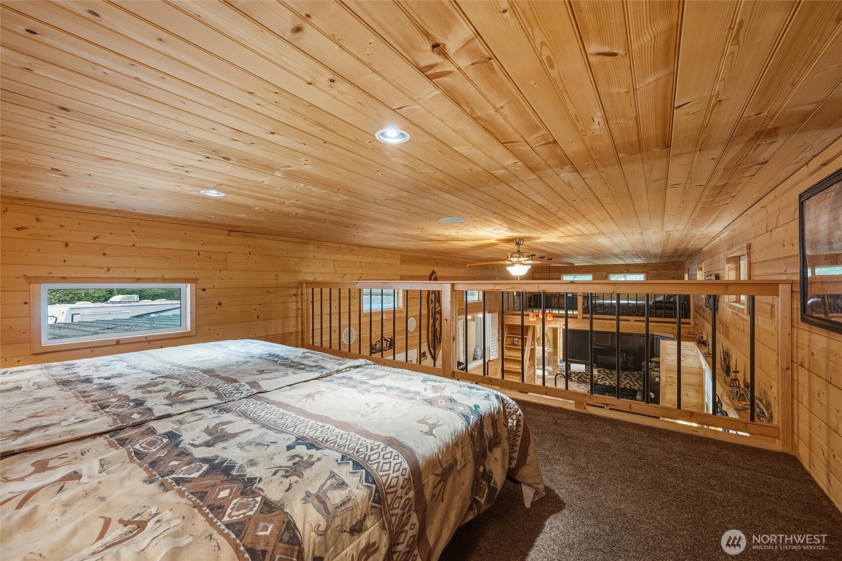 1015 Maple Lane Maple Falls, WA 98266 - Photo 23 of 39 a spacious bedroom with a large bed and a chandelier