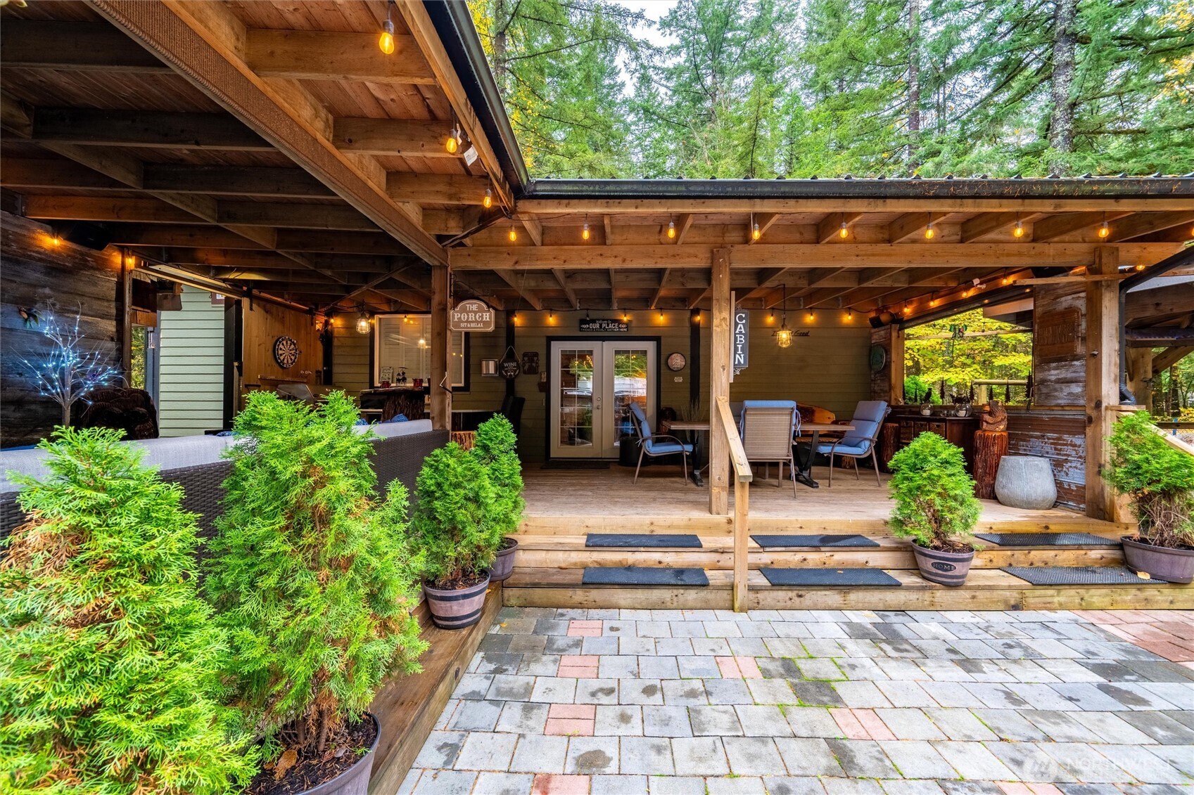 1015 Maple Lane Maple Falls, WA 98266 - Photo 25 of 39 a view of a patio with table and chairs potted plants and floor to ceiling window