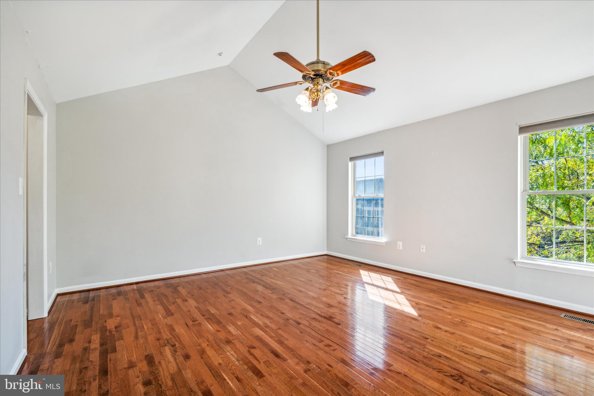 2442 Rippling Brook Road Frederick, MD 21701 - Photo 26 of 85 a view of an empty room with wooden floor and a window
