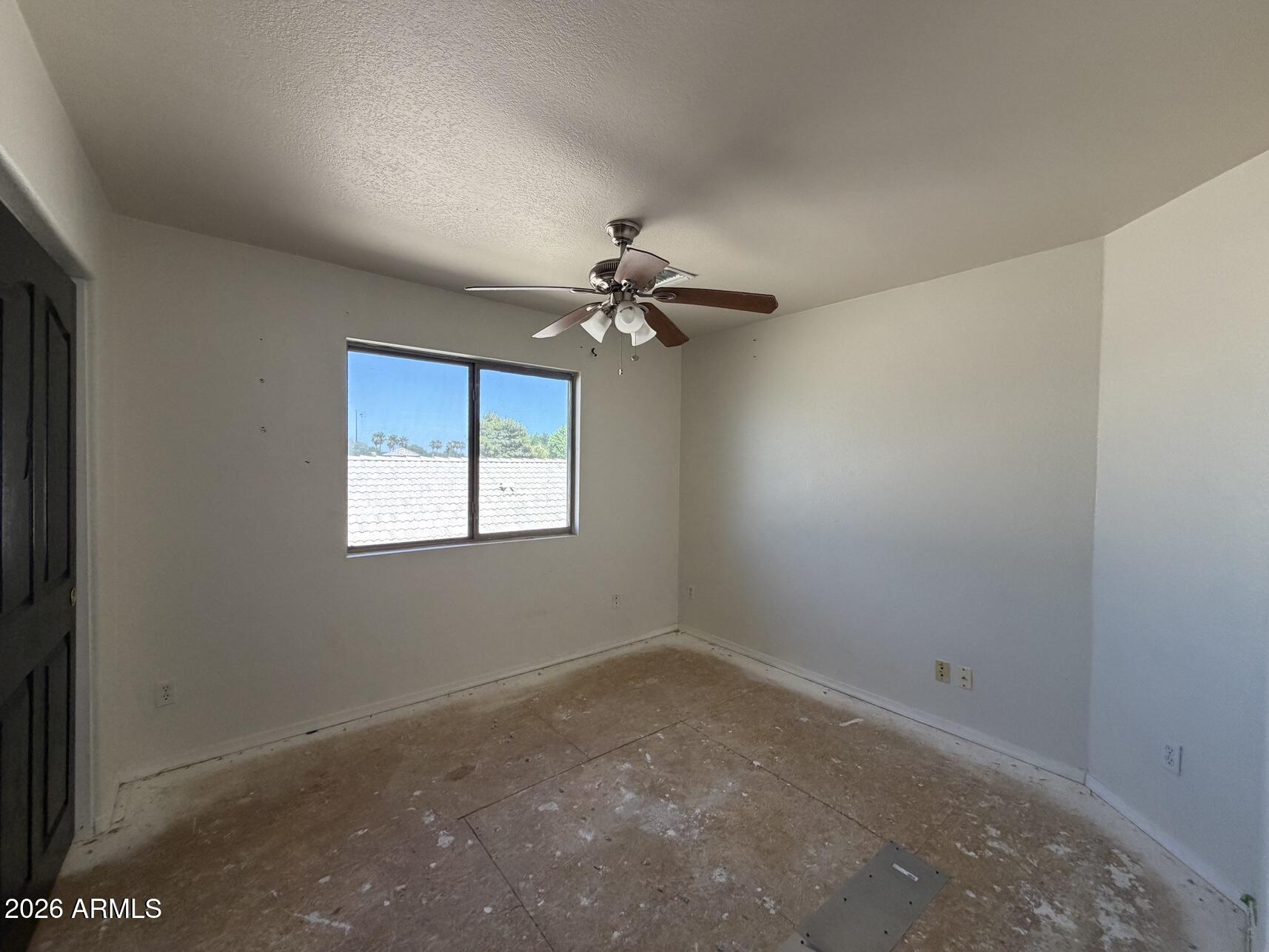 10807 West Monte Vista Road Avondale, AZ 85392 - Photo 20 of 33 a view of a room with a ceiling fan and a window