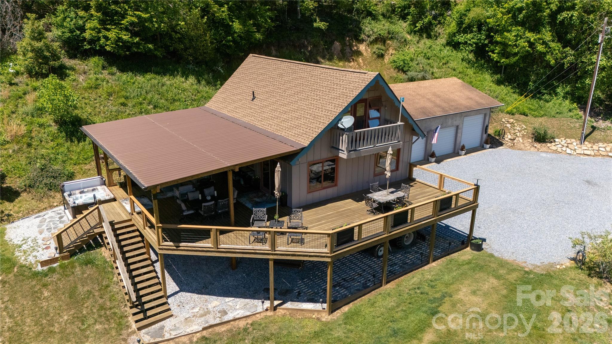 93 Franklin Crest Road Spruce Pine, NC 28777 - Photo 4 of 47 an aerial view of a house with swimming pool and trees in the background