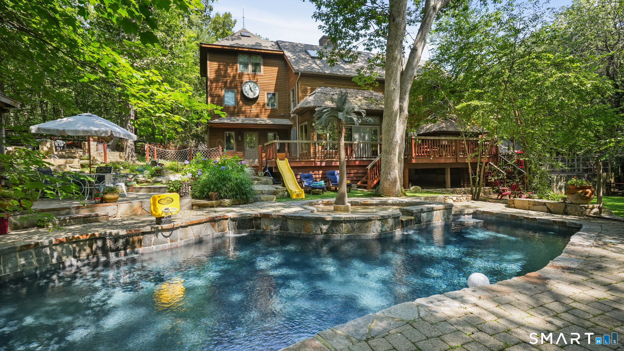 142 Seventy Acre Road Redding, CT 06896 - Photo 22 of 40 a view of a house with swimming pool and sitting area