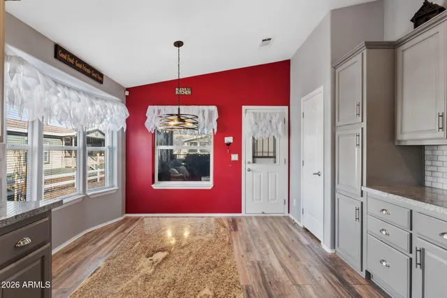 a view of an empty room with window and cabinet