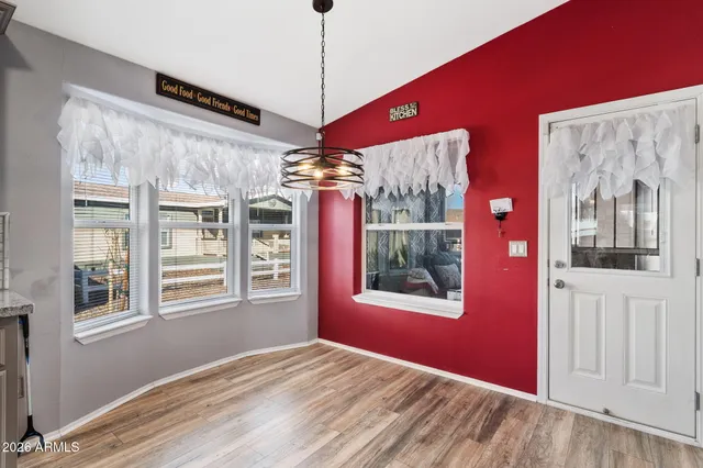 a view of a livingroom with a window and wooden floor