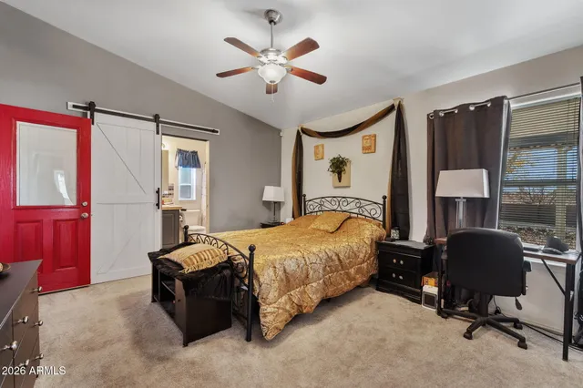 a bedroom with a bed and a chandelier