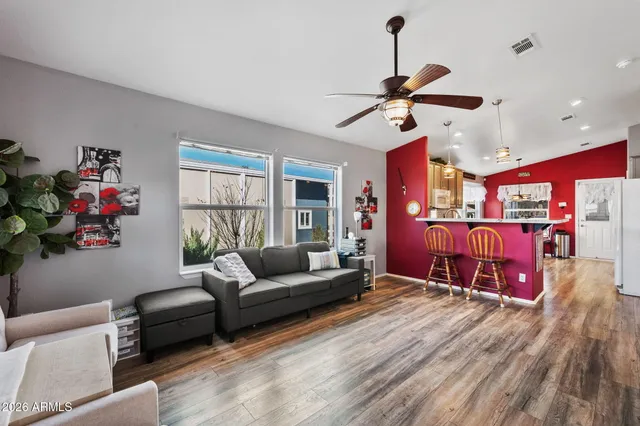a living room with furniture ceiling fan and a window