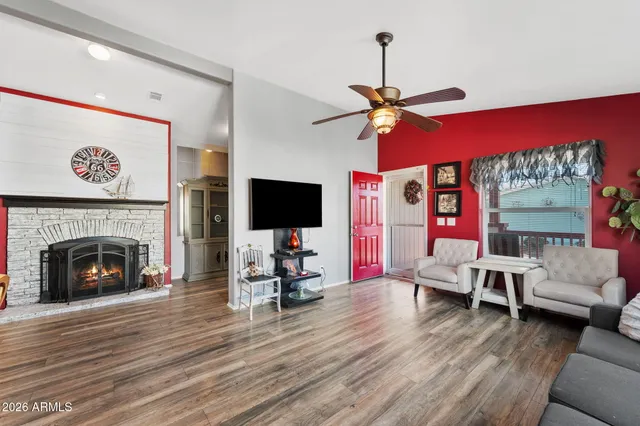 a living room with furniture a flat screen tv and a fireplace