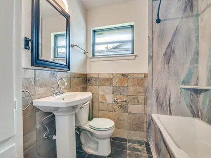 a bathroom with a sink toilet and shower