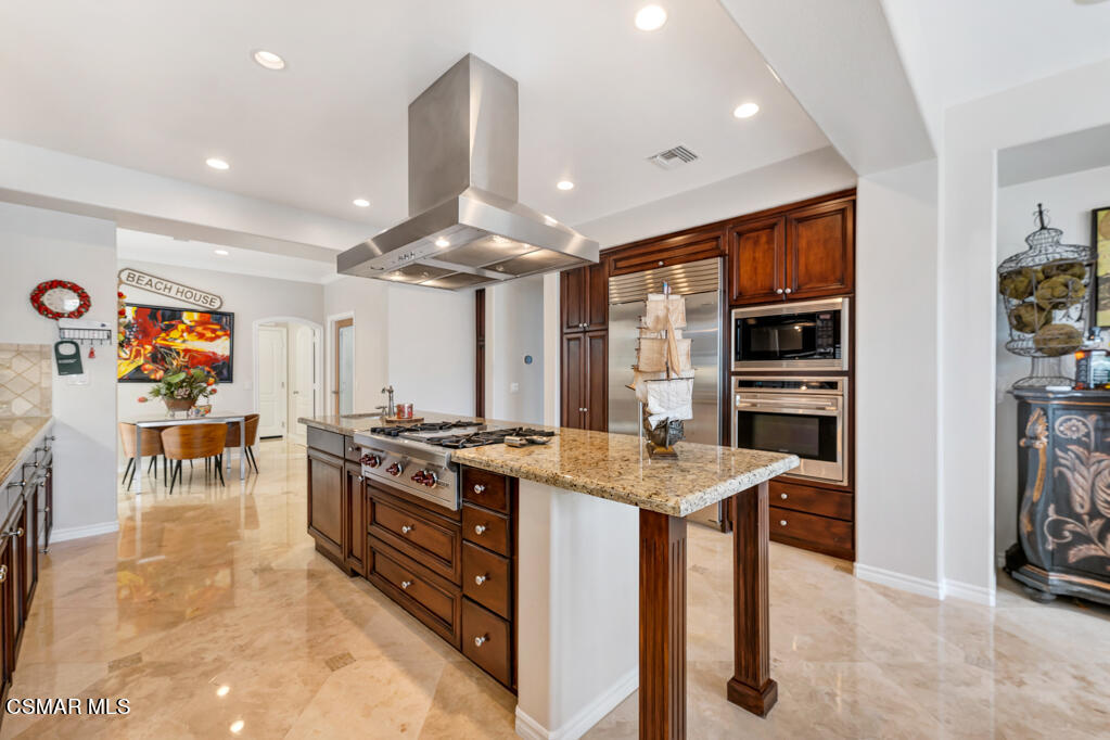 1410 Viewpoint Drive Oxnard, CA 93035 - Photo 22 of 73 a kitchen with stainless steel appliances granite countertop table chairs and a refrigerator