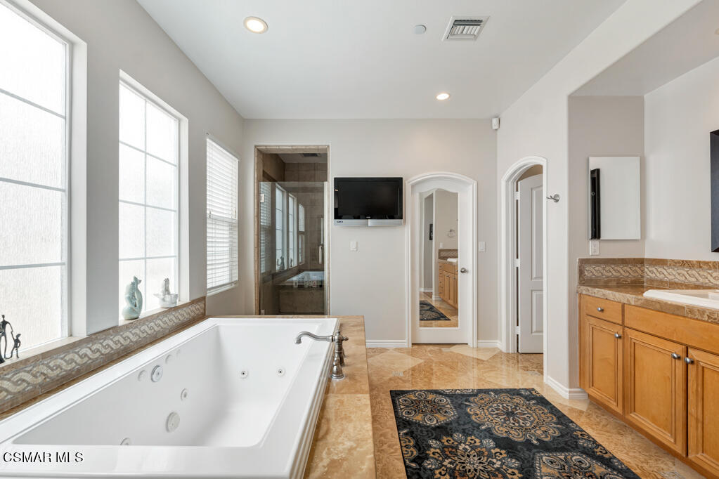 1410 Viewpoint Drive Oxnard, CA 93035 - Photo 37 of 73 a bathroom with a tub a sink and a large window