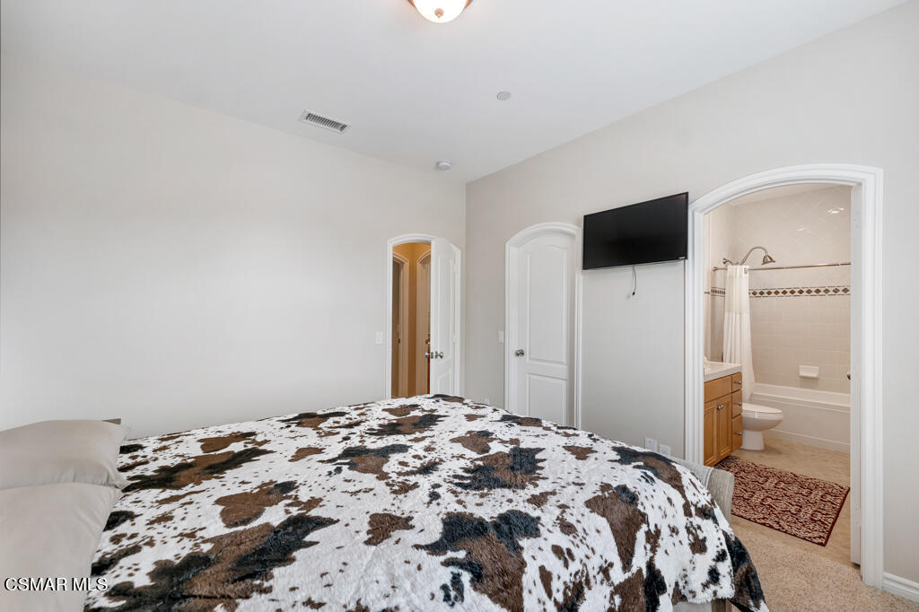 1410 Viewpoint Drive Oxnard, CA 93035 - Photo 48 of 73 a bedroom with a bed and a flat screen tv
