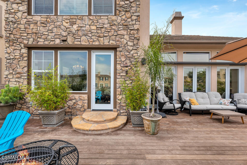 1410 Viewpoint Drive Oxnard, CA 93035 - Photo 64 of 73 a view of a patio with couches table and chairs potted plants and wooden floor