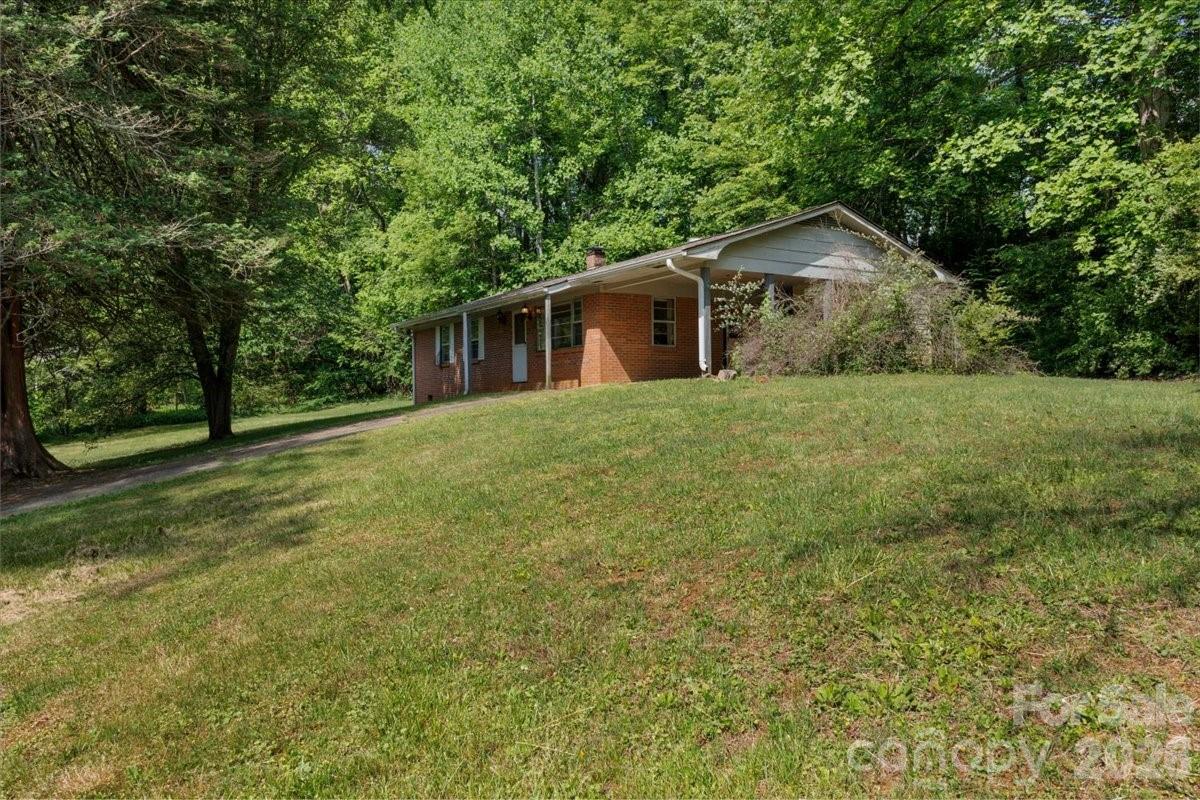 156 Old Sweetwater Road Robbinsville, NC 28771 - Photo 3 of 25 a front view of house with yard and trees