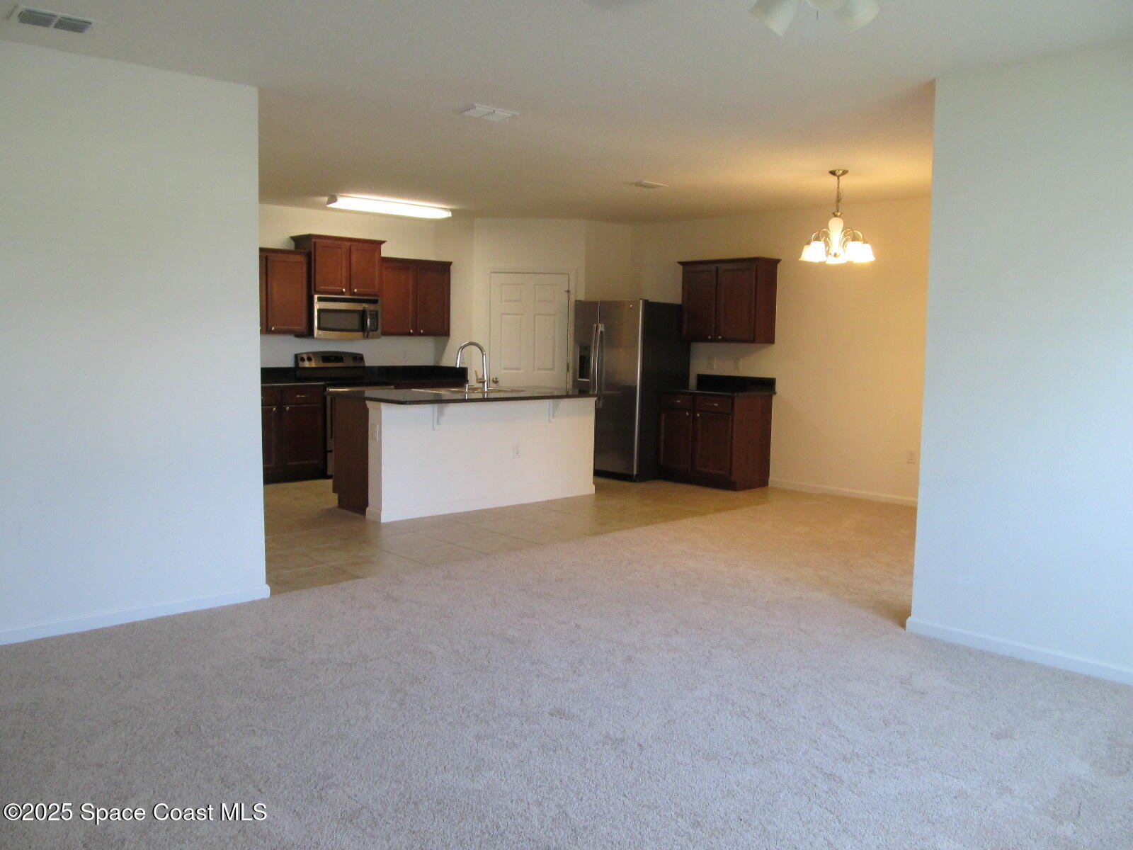 2002 Elkins Point Melbourne, FL 32935 - Photo 10 of 25 Kitchen View from Living Room
