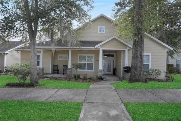 a front view of a house with a yard and porch